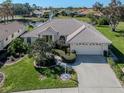 Charming home featuring a well-manicured lawn and a spacious two car garage at 5071 Winter Rose Way, Venice, FL 34293