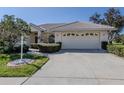 Attractive home with a manicured front lawn and a convenient two-car garage at 5071 Winter Rose Way, Venice, FL 34293