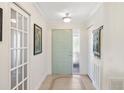 Inviting foyer with tile flooring, glass paneled doors, and neutral walls that create a bright and welcoming space at 537 Foxwood Blvd, Englewood, FL 34223