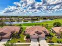 Gorgeous aerial shot of property showing landscaping, golf course, and lake views at 5371 White Ibis Dr, North Port, FL 34287