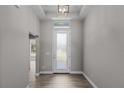 Interior entryway with gray walls and wood-look tile flooring at 7057 Regina Dr, Englewood, FL 34224