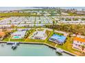 Aerial view of waterfront home with pool and private dock at 721 Binnacle Point Dr, Longboat Key, FL 34228