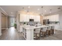 Spacious kitchen with white cabinets, quartz counters, and island at 25488 Calusa Dr, Punta Gorda, FL 33955