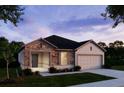 One-story house with stone accents and a two-car garage at 25533 Calusa Dr, Punta Gorda, FL 33955
