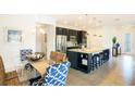 Bright dining area with glass table and blue patterned chairs at 3194 Cabo St, North Port, FL 34291