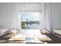 Bright dining room with water views and elegant chandelier at 9715 Harrell Ave # 40, Treasure Island, FL 33706