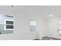 Bright and airy living room with large windows and hardwood floors at 1005 Signet, Apollo Beach, FL 33572