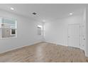 Bright bedroom with wood-look tile flooring and neutral wall colors at 17355 Peregrine Way, Punta Gorda, FL 33982