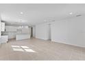 Open living room and kitchen area with tile floors at 9572 Vibrant Lane, Venice, FL 34292