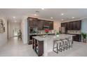 Open concept kitchen featuring granite island and stainless steel appliances at 25134 Doredo Dr, Punta Gorda, FL 33955