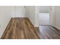 Bright foyer with wood-look flooring and doors leading to other rooms at 37488 Williamette Way, Zephyrhills, FL 33540