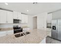 Modern kitchen with granite countertops and white cabinets at 428 Lazy Shore Dr, Nokomis, FL 34275