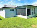 Screened porch and grassy backyard at 7524 Oakshire Dr, Port Richey, FL 34668