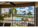 Relaxing pool area with water views and a thatched umbrella at 6268 Palma Del Mar S Blvd # 204, St Petersburg, FL 33715