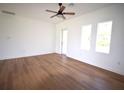 Spacious bedroom with wood flooring and access to the outdoors at 23335 Mac Dougall Ave, Port Charlotte, FL 33980