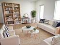 Bright and airy living room with modern furniture and large bookcase at 23335 Mac Dougall Ave, Port Charlotte, FL 33980