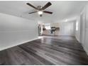 View of living room, kitchen, and wood-look floors at 1220 36Th W Ave, Bradenton, FL 34205
