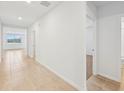 Bright hallway with tile flooring and doors leading to other rooms at 7760 Gilchrist Springs Dr, Parrish, FL 34219