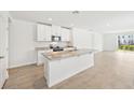 Modern kitchen with granite countertops and a breakfast bar at 444 Lazy Shore Dr, Nokomis, FL 34275