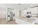 Modern kitchen with stainless steel appliances and granite countertops at 444 Lazy Shore Dr, Nokomis, FL 34275