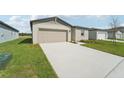 New construction home with a driveway and landscaped front yard at 184 Lazy Shore Dr, Nokomis, FL 34275