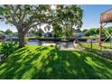 Waterfront backyard with a dock and lush green grass at 14914 Capri Ln, Hudson, FL 34667