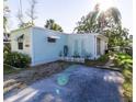 Side view of the light blue home, showing the backyard at 14914 Capri Ln, Hudson, FL 34667