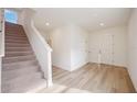 Bright entryway with stairs, light wood flooring, and neutral walls at 37545 Mackenzie Dr, Zephyrhills, FL 33540