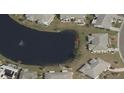 Property's aerial view showing its location on a lake at 906 Bluewater Dr, Sun City Center, FL 33573