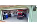 Garage with golf cart, motorcycle, and storage shelves at 906 Bluewater Dr, Sun City Center, FL 33573