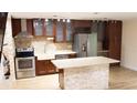 Remodeled kitchen with modern appliances, stone island and wooden cabinets at 11410 8Th N Way # 310, St Petersburg, FL 33716
