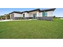 Front view of a modern home with a neatly landscaped yard at 16229 Cape Horn Blvd, Punta Gorda, FL 33955