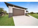 Brown garage door and spacious driveway in front of the house at 16229 Cape Horn Blvd, Punta Gorda, FL 33955