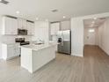 Modern kitchen with white cabinets and a center island at 169 Lazy Shore Dr, Nokomis, FL 34275