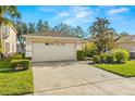 Single story house with a two-car garage and manicured lawn at 7851 Tuscany Woods Dr, Tampa, FL 33647