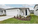 House exterior showcasing a garage and neatly landscaped yard at 14052 Crutchfield Ct, Parrish, FL 34219