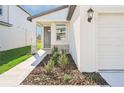 One-story home with white exterior, gray door, and stone accents at 14053 Crutchfield Ct, Parrish, FL 34219