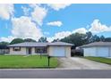 Ranch-style home with a large yard and attached garage at 2587 Blackwood Cir, Clearwater, FL 33763