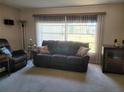 Living room with a couch, recliner, and large windows at 2587 Blackwood Cir, Clearwater, FL 33763