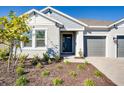 Two-story home with gray two-car garage and manicured landscaping at 1564 Laurel Brook Ln, Port Charlotte, FL 33953