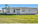 Front view of the house with landscaping and a lake view at 16093 Ivy Ridge Ct, Port Charlotte, FL 33953