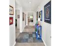 Bright entryway with blue accent table and view to living room at 7729 Rosewood Garden Loop, Tampa, FL 33637