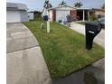 House exterior view with a yard, driveway, and mailbox at 3741 Baden Dr, Holiday, FL 34691