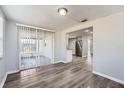 Spacious dining area with wood-look floors and access to the backyard at 7311 Buchanan Dr, Port Richey, FL 34668