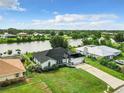 Aerial view of canal-front home with large backyard and detached garage at 7384 Van Lake Dr, Englewood, FL 34224