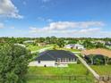 Backyard view, showcasing screened patio and fenced yard at 7384 Van Lake Dr, Englewood, FL 34224