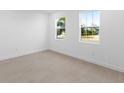 Bright bedroom with tile floors and two large windows at 1044 Signet Dr, Apollo Beach, FL 33572