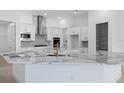 Modern kitchen featuring white cabinets and a large island at 1044 Signet Dr, Apollo Beach, FL 33572