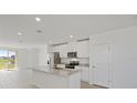 Modern kitchen with island, stainless steel appliances, and granite countertops at 120 Whiteland Bnd, Nokomis, FL 34275