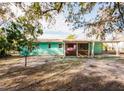 House with screened porch and a large backyard at 7256 Pinehurst Dr, Spring Hill, FL 34606